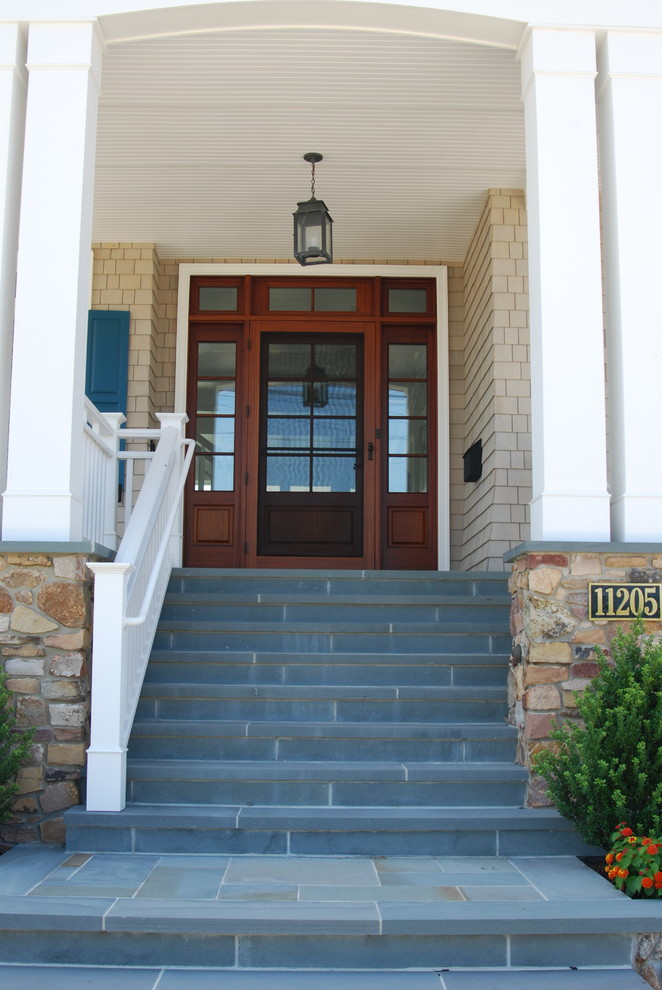 This is an example of a beach style front door in Other with a single front door and a medium wood front door.