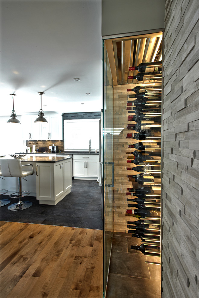Inspiration for a small modern wine cellar in Montreal with ceramic floors and display racks.