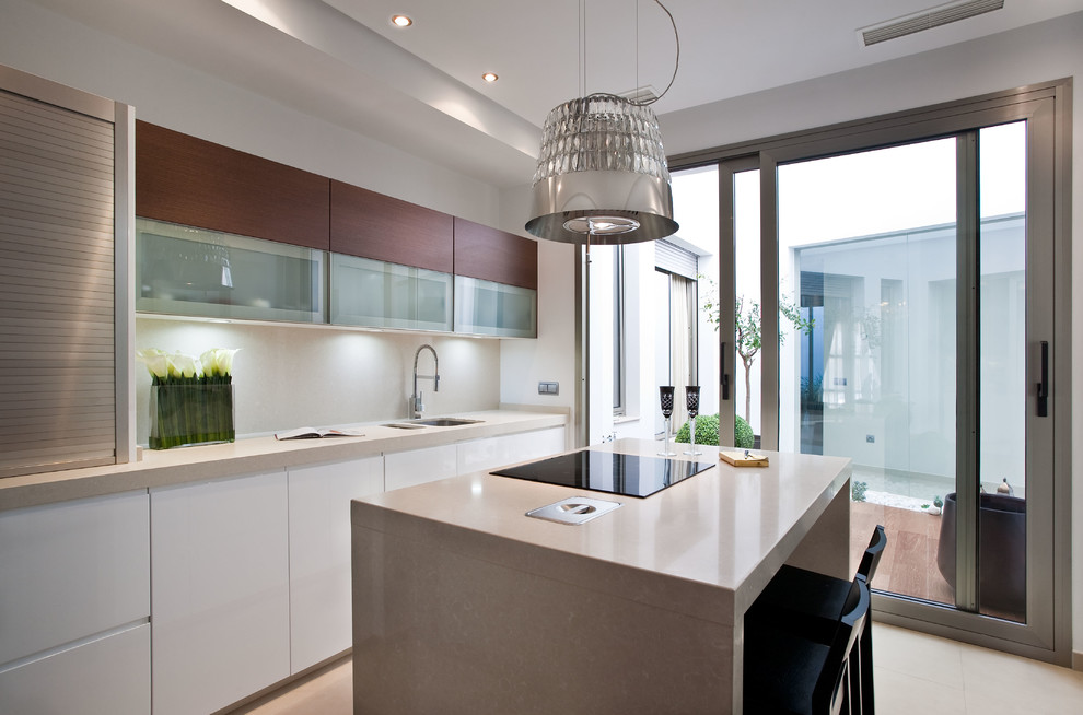 Design ideas for a contemporary kitchen in Seville with with island, a double-bowl sink, flat-panel cabinets, white cabinets, beige splashback, beige floor and beige benchtop.