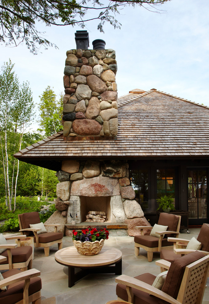 This is an example of an eclectic patio in Minneapolis with a fire feature.