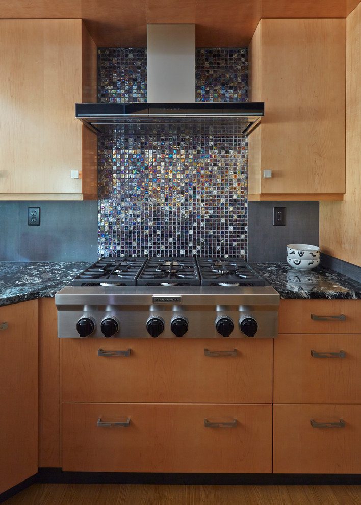 Kitchen - contemporary medium tone wood floor kitchen idea in Baltimore with an undermount sink, flat-panel cabinets, medium tone wood cabinets, gray backsplash, stone slab backsplash and stainless steel appliances