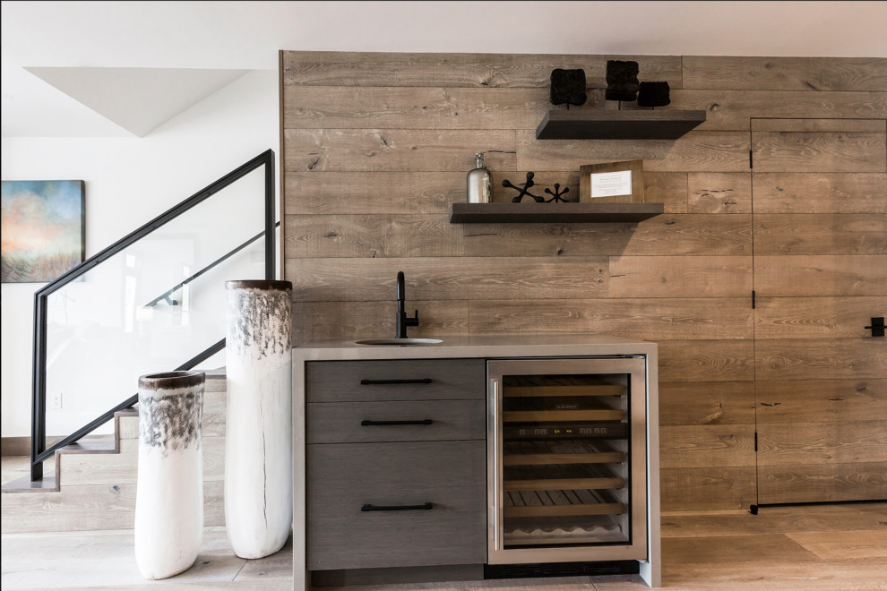 Inspiration for a small contemporary wet bar in Salt Lake City with an undermount sink, flat-panel cabinets, quartz benchtops, timber splashback and light hardwood floors.