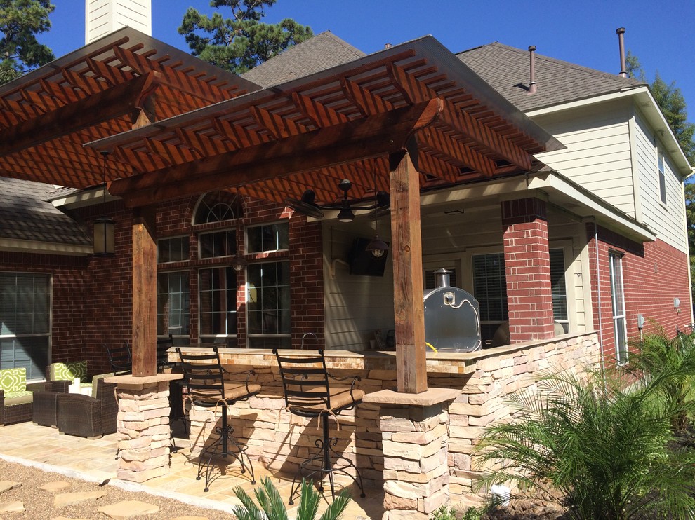 Inspiration for a large contemporary backyard patio in Houston with an outdoor kitchen, tile and a pergola.