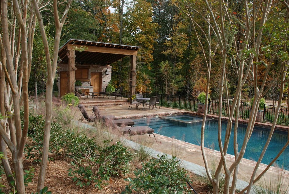 Example of a large transitional backyard concrete and rectangular lap hot tub design in New Orleans