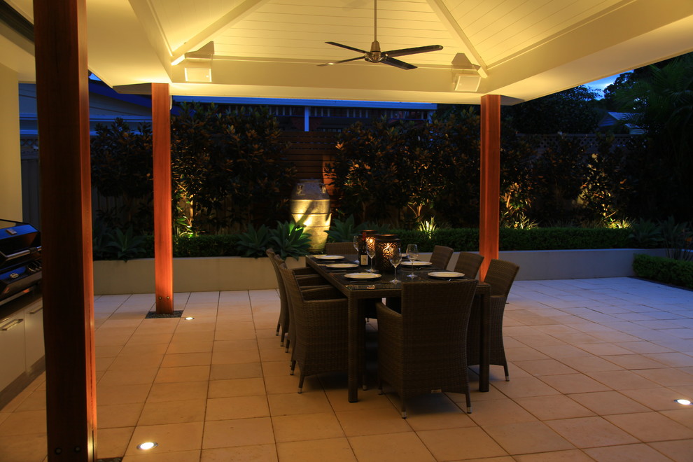 Photo of a mid-sized contemporary side yard patio in Sydney with an outdoor kitchen, concrete pavers and an awning.