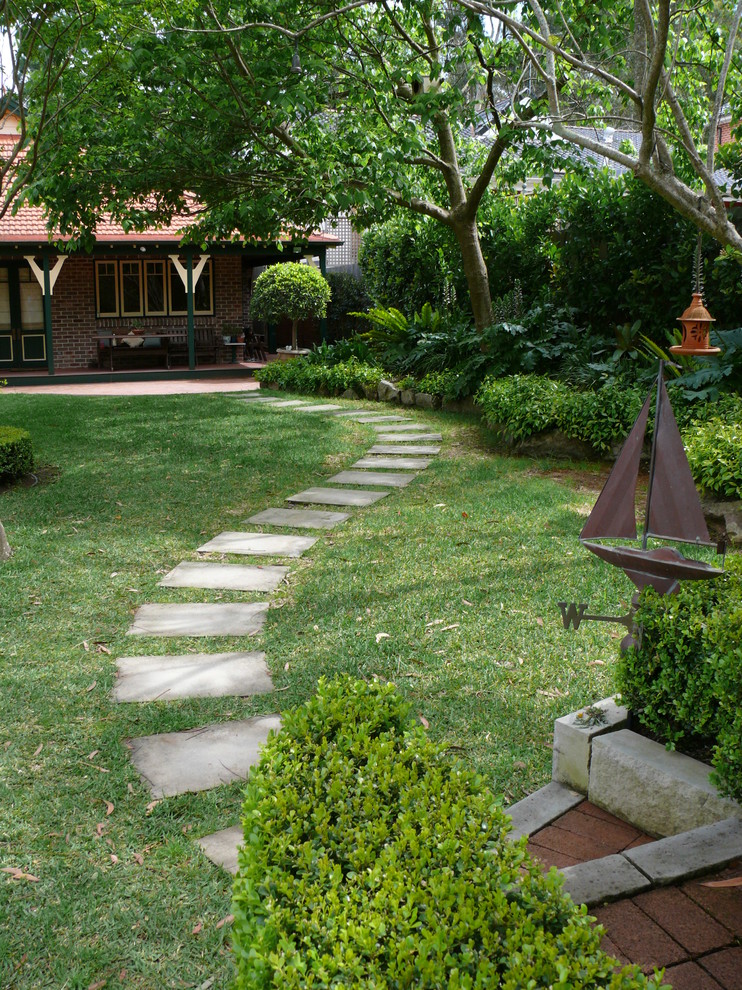 Design ideas for a large traditional backyard partial sun garden in Sydney with a garden path and natural stone pavers.