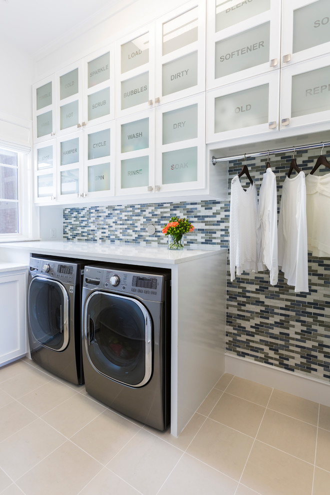 Contemporary l-shaped laundry room in Houston with glass-front cabinets, white cabinets, multi-coloured walls, ceramic floors, a side-by-side washer and dryer and white benchtop.