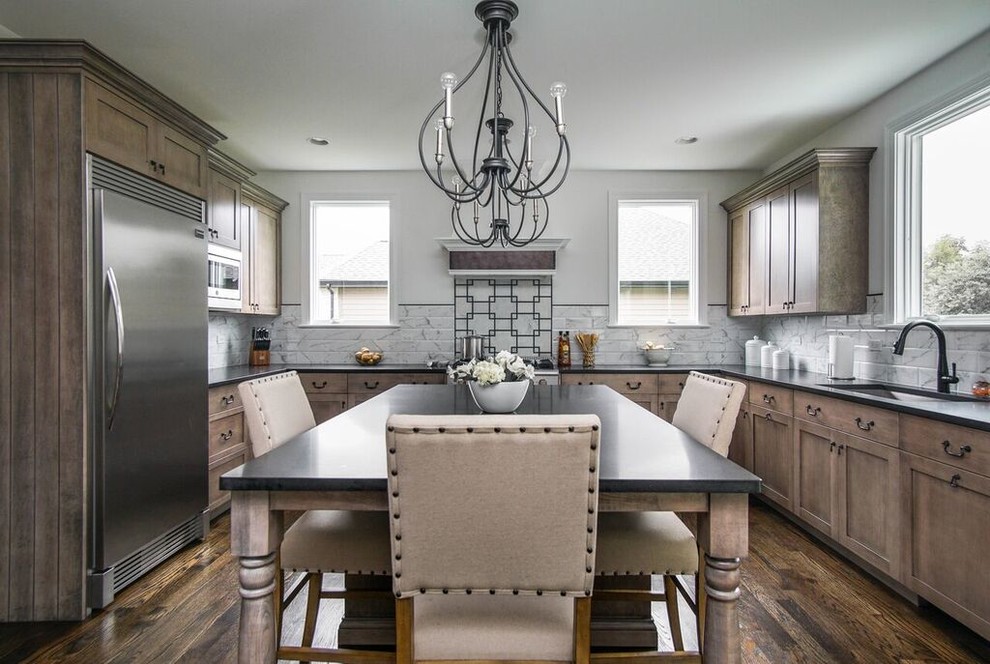 Inspiration for a transitional u-shaped dark wood floor and black floor eat-in kitchen remodel in Chicago with an undermount sink, shaker cabinets, granite countertops, white backsplash, ceramic backsplash, stainless steel appliances, an island and black countertops