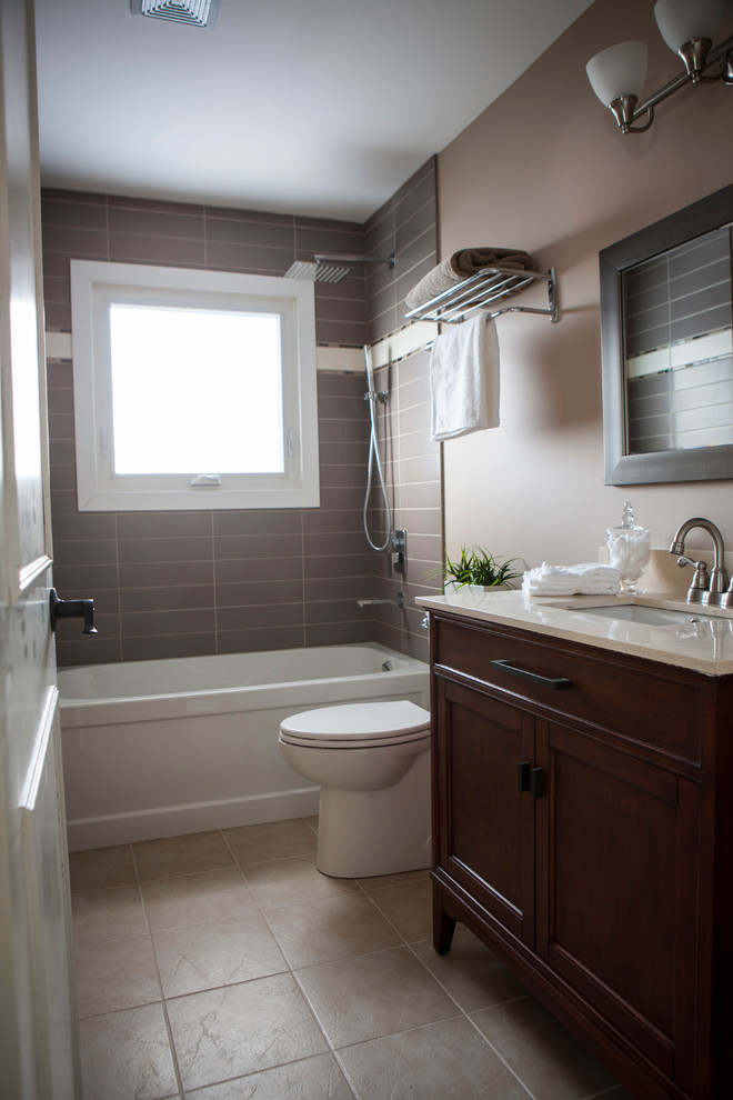 Mid-sized transitional bathroom in Other with an undermount sink, shaker cabinets, medium wood cabinets, marble benchtops, an alcove tub, an alcove shower, a one-piece toilet, beige tile, porcelain tile, beige walls and ceramic floors.