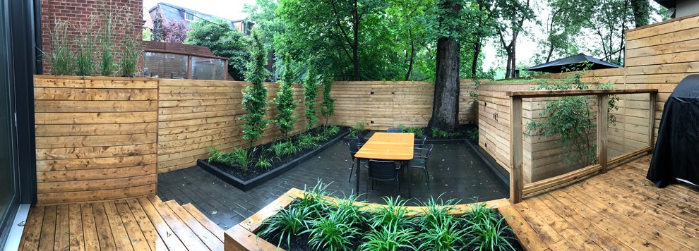 Small modern backyard partial sun garden in Toronto with a garden path and brick pavers for summer.