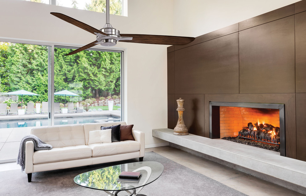 Photo of a contemporary living room with a standard fireplace and no tv.