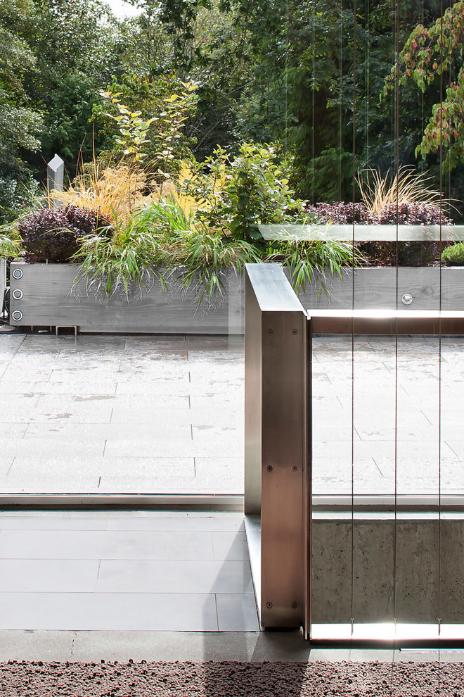 This is an example of an expansive modern concrete straight staircase in Vancouver with concrete risers.