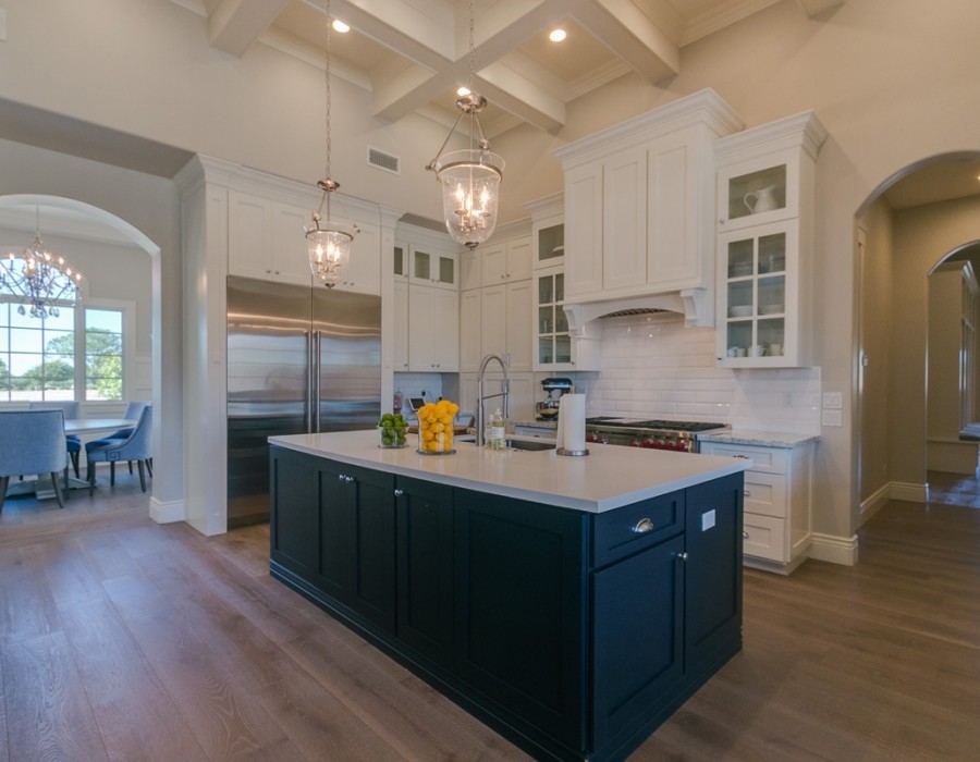 Large transitional l-shaped dark wood floor and brown floor open concept kitchen photo in Phoenix with an undermount sink, shaker cabinets, white cabinets, quartz countertops, white backsplash, subway tile backsplash, stainless steel appliances and two islands