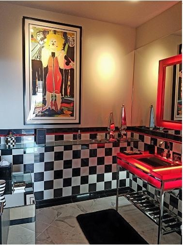 Inspiration for a mid-sized modern black and white tile and cement tile white floor powder room remodel in Hawaii with beige walls, an undermount sink, glass countertops and red countertops