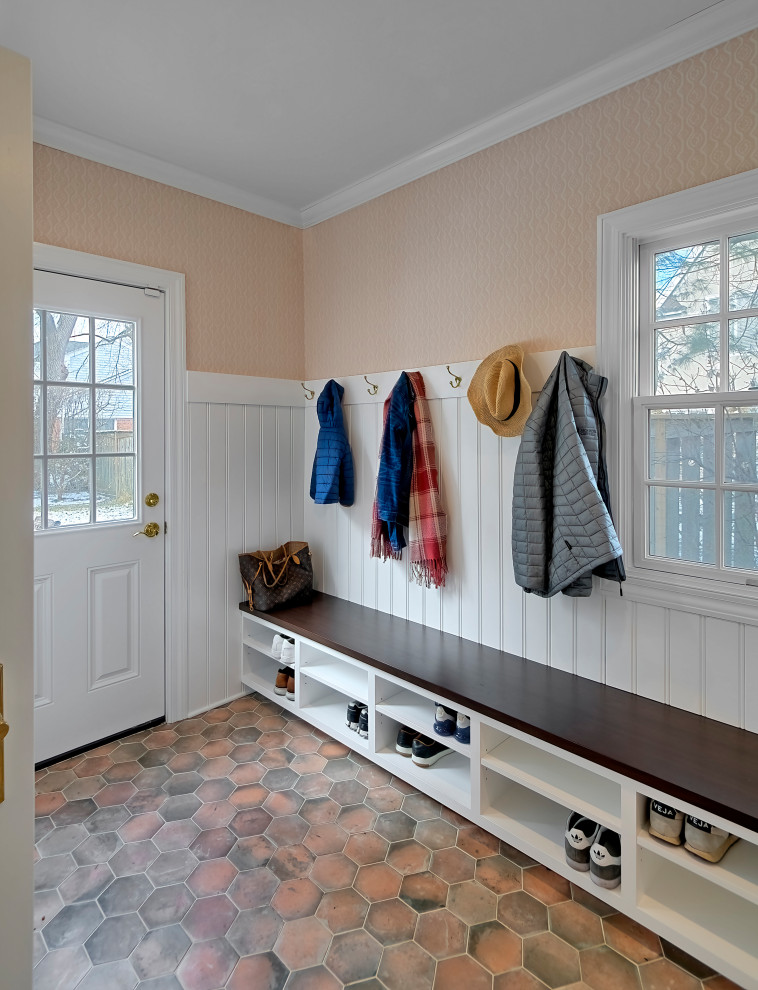 Photo of a mid-sized transitional mudroom in Chicago with multi-coloured walls, ceramic floors, multi-coloured floor and planked wall panelling.