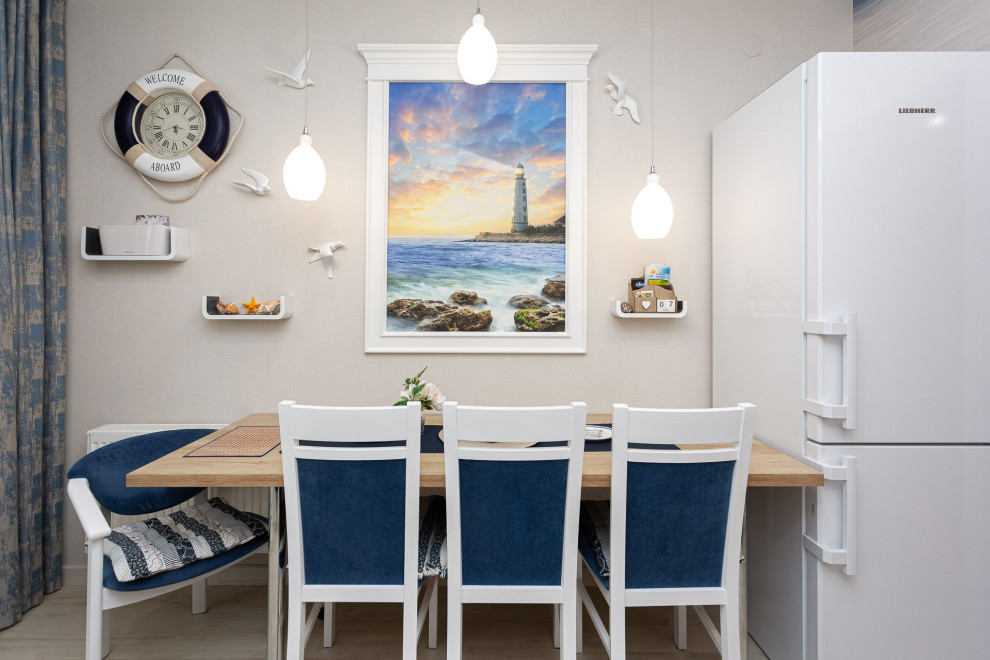 Design ideas for a mid-sized beach style galley separate kitchen in Other with an undermount sink, recessed-panel cabinets, blue cabinets, wood benchtops, grey splashback, ceramic splashback and laminate floors.