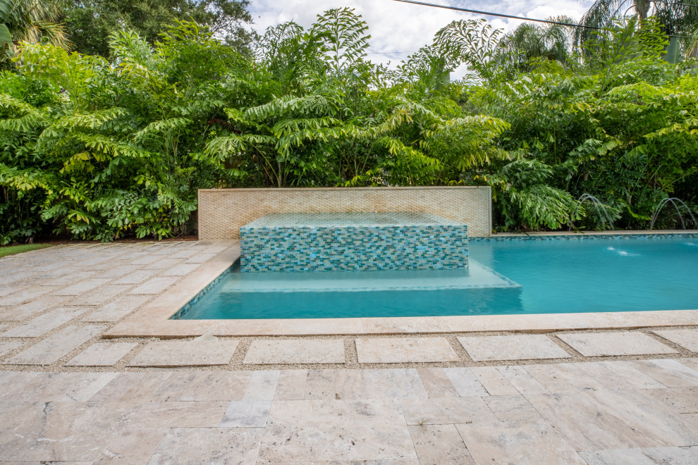 Example of a transitional natural pool landscaping design in Miami with decking