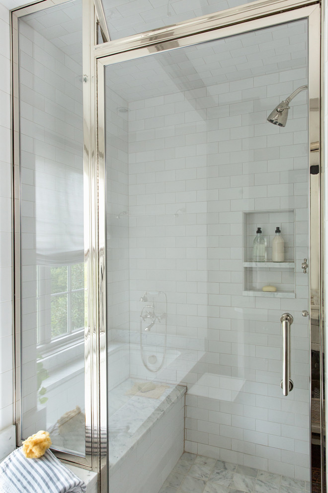 Mid-sized transitional 3/4 bathroom in Raleigh with a corner shower, a hinged shower door, white tile, subway tile, marble floors and grey floor.