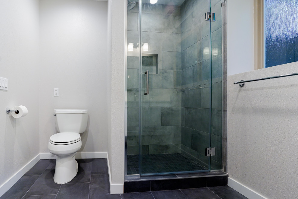 This is an example of a mid-sized contemporary kids bathroom in Seattle with shaker cabinets, white cabinets, an open shower, gray tile, porcelain tile, white walls, porcelain floors, an undermount sink, engineered quartz benchtops, multi-coloured floor, a hinged shower door, white benchtops, a laundry, a single vanity and a floating vanity.