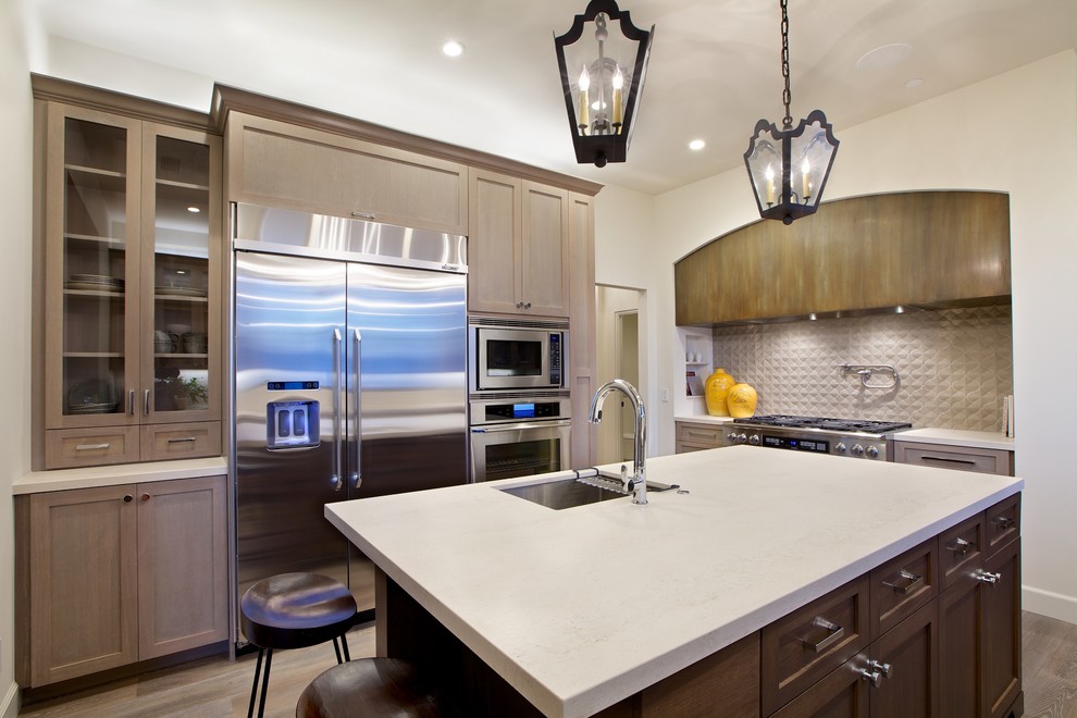Photo of a large transitional single-wall separate kitchen in San Diego with an undermount sink, shaker cabinets, brown cabinets, quartzite benchtops, stainless steel appliances, medium hardwood floors, with island and brown floor.
