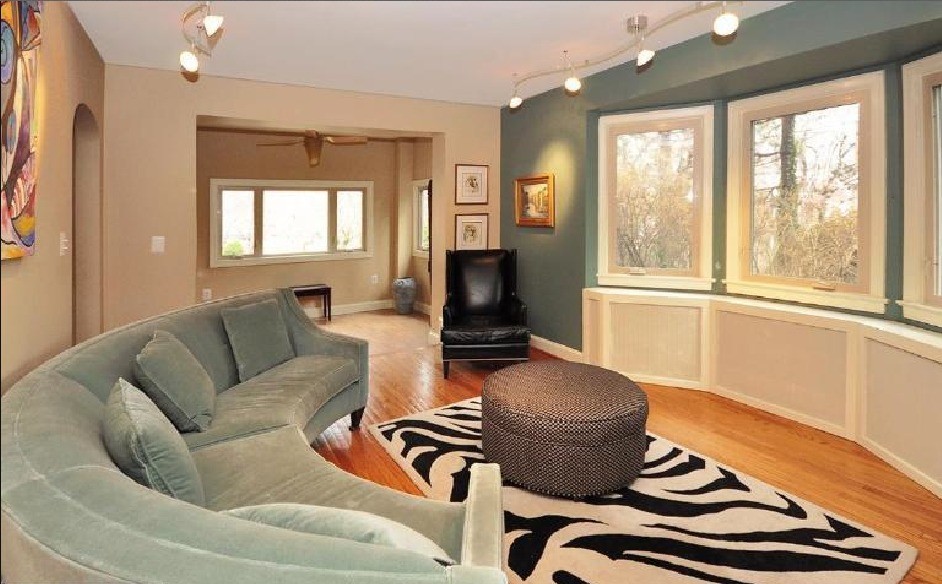 Mid-sized eclectic formal enclosed living room in DC Metro with green walls, medium hardwood floors, no fireplace, no tv and beige floor.