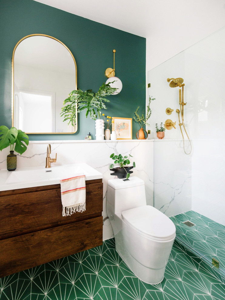 Design ideas for a mid-sized contemporary 3/4 bathroom in Orange County with flat-panel cabinets, medium wood cabinets, a corner shower, a one-piece toilet, white tile, green walls, an integrated sink, green floor and white benchtops.