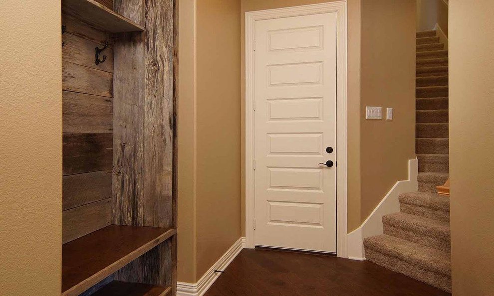 Inspiration for a mid-sized arts and crafts hallway in Dallas with brown walls, medium hardwood floors and brown floor.