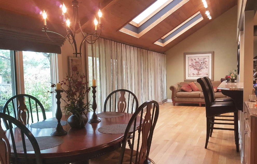 This is an example of an expansive eclectic open plan dining in Denver with grey walls and medium hardwood floors.