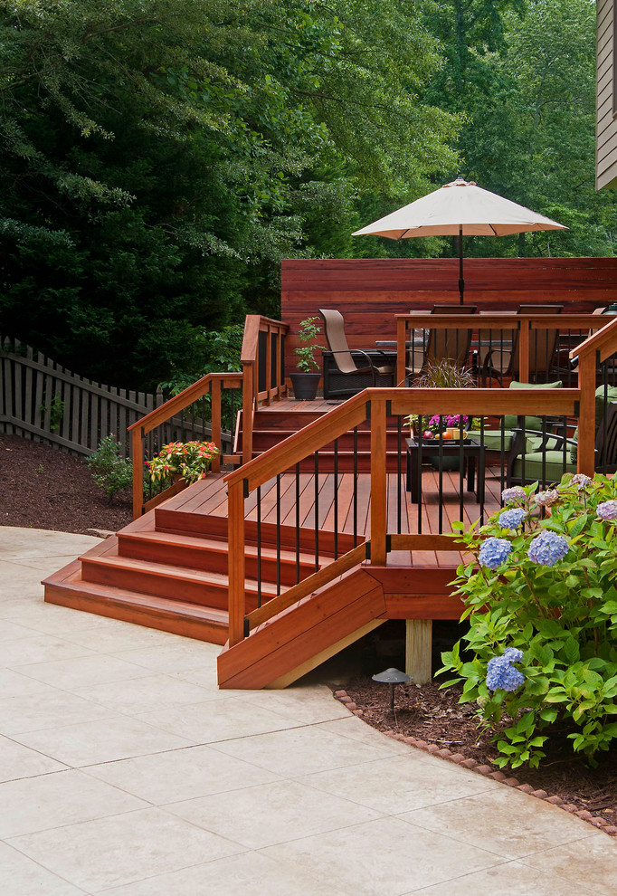 This is an example of a mid-sized transitional backyard deck in Atlanta with no cover.