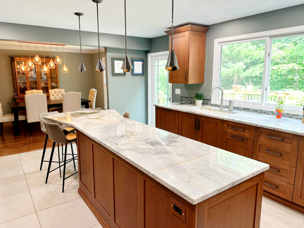 Example of a mid-sized transitional porcelain tile and gray floor eat-in kitchen design with recessed-panel cabinets, medium tone wood cabinets, quartzite countertops, green backsplash, mosaic tile backsplash, stainless steel appliances and an island