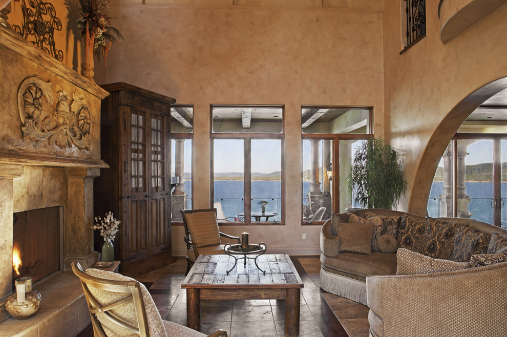 Inspiration for a mediterranean living room in Austin with beige walls and a standard fireplace.