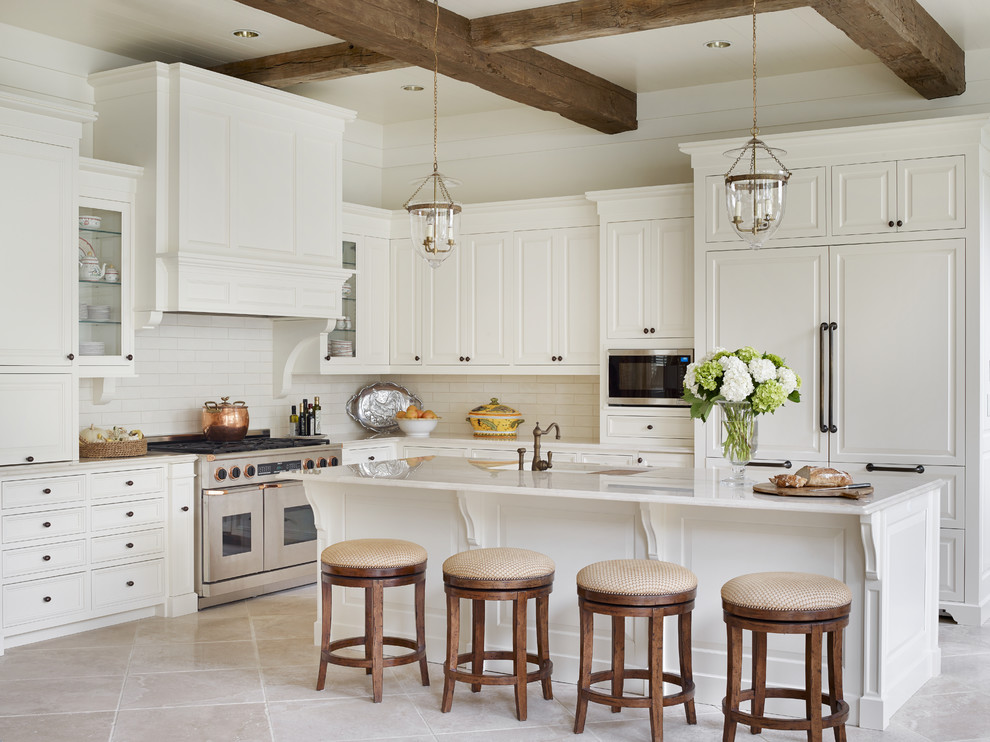 Inspiration for a large traditional l-shaped open plan kitchen in Atlanta with raised-panel cabinets, white cabinets, white splashback, subway tile splashback, panelled appliances, with island, an undermount sink, granite benchtops and limestone floors.