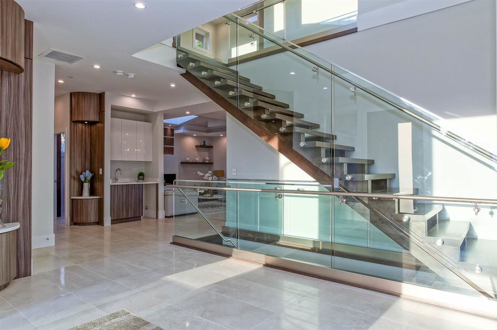 Expansive modern wood straight staircase in Vancouver with open risers and glass railing.