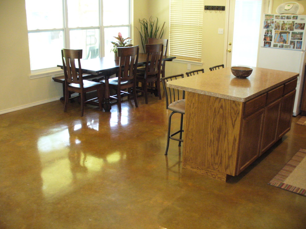 Inspiration for a mid-sized transitional concrete floor and brown floor kitchen/dining room combo remodel in Austin with beige walls and no fireplace