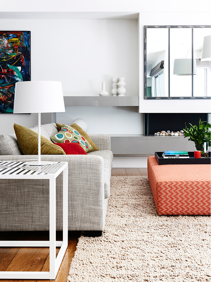 Contemporary open concept living room in Melbourne with white walls, a standard fireplace and a plaster fireplace surround.