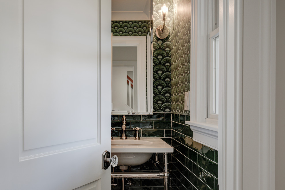 Example of a mid-sized transitional green tile and ceramic tile mosaic tile floor, multicolored floor and wallpaper powder room design with a one-piece toilet, green walls, an undermount sink, solid surface countertops and white countertops