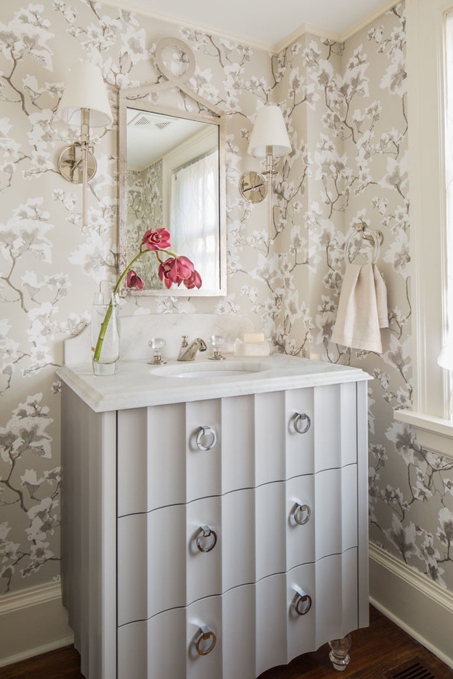 Photo of a traditional powder room in Providence with furniture-like cabinets, an undermount sink, beige walls and grey cabinets.