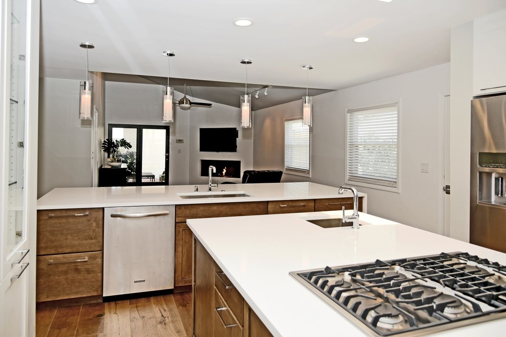 Inspiration for a transitional eat-in kitchen remodel in Los Angeles with an undermount sink, shaker cabinets, quartz countertops, stainless steel appliances, two islands and distressed cabinets