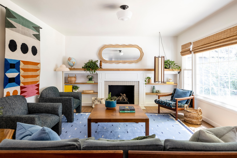 Design ideas for a mid-sized eclectic open concept living room in Sacramento with white walls, medium hardwood floors, a standard fireplace, a brick fireplace surround and brown floor.
