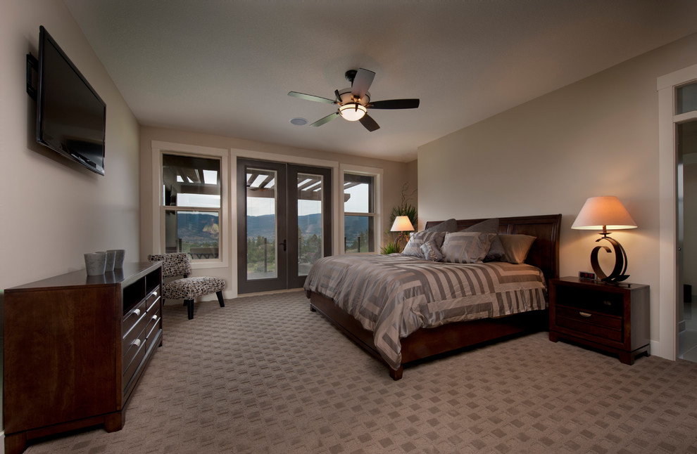 This is an example of a large arts and crafts master bedroom in Vancouver with brown walls and carpet.