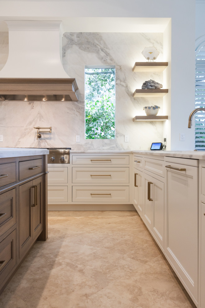 Transitional u-shaped kitchen photo with marble countertops and an island