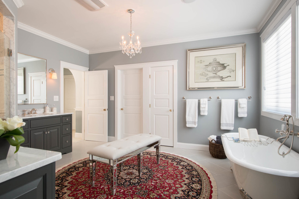 Mid-sized traditional master bathroom in Boston with raised-panel cabinets, grey cabinets, a freestanding tub, grey walls, porcelain floors, an undermount sink, engineered quartz benchtops and white floor.