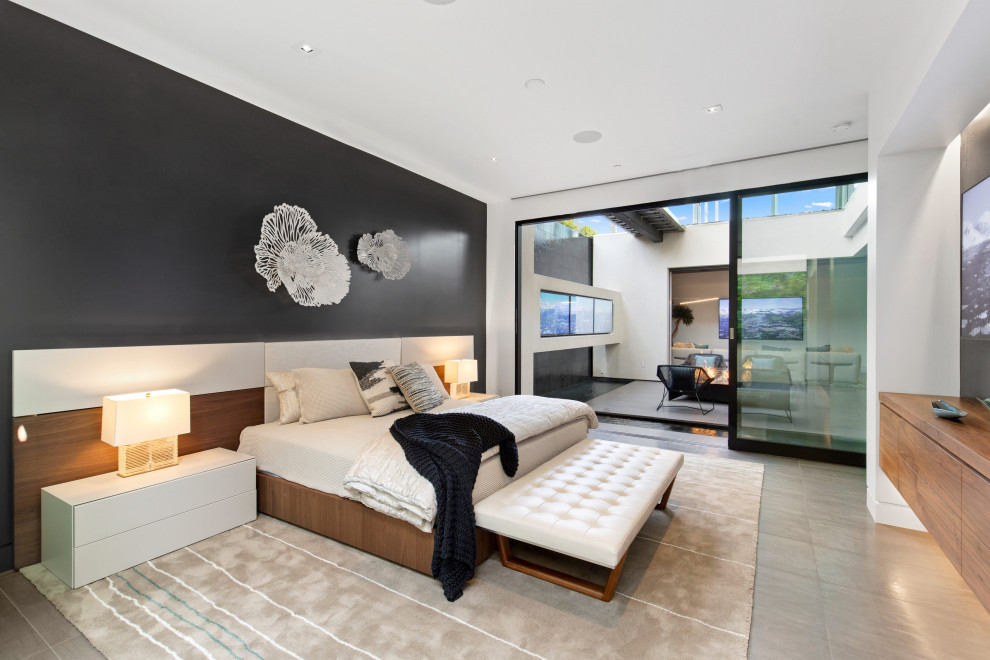 Large contemporary guest bedroom in San Diego with black walls, ceramic floors and beige floor.