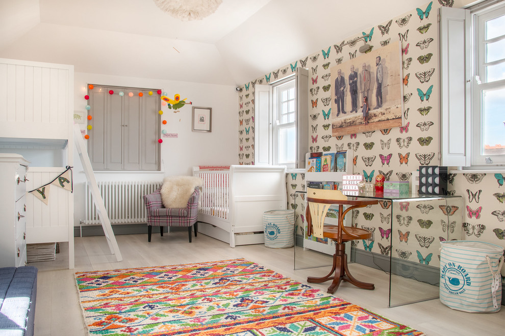 Contemporary nursery in London with multi-coloured walls and beige floor.