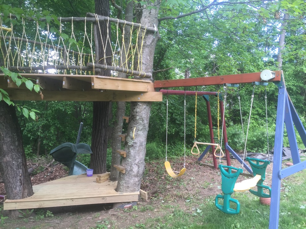 Design ideas for a backyard garden in Boston with with outdoor playset.