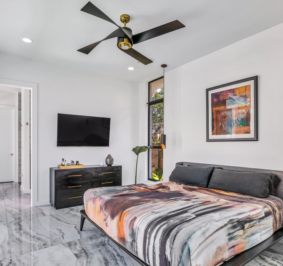 Photo of a large midcentury bedroom in Tampa with white walls and marble floors.