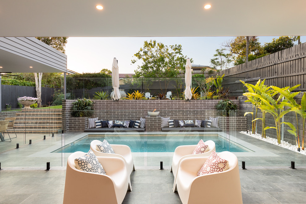 Photo of a contemporary backyard patio in Brisbane with a roof extension.