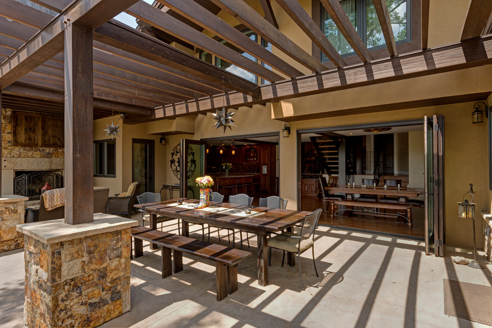Traditional backyard patio in Denver with a pergola.