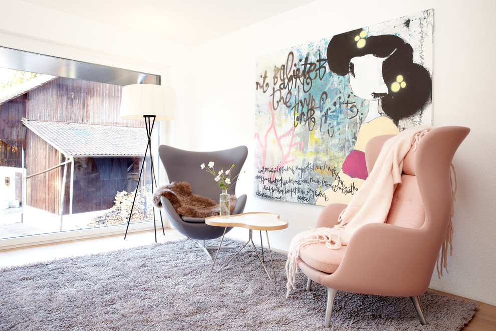 Mid-sized scandinavian formal enclosed living room in Hamburg with white walls, medium hardwood floors, beige floor, no fireplace and no tv.