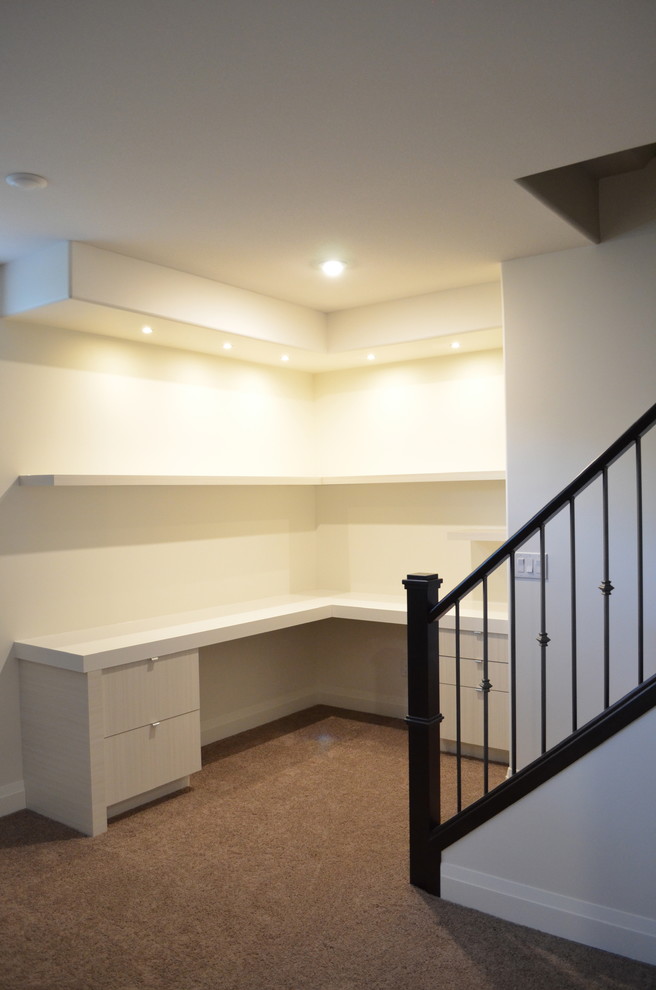Transitional carpeted basement photo with gray walls
